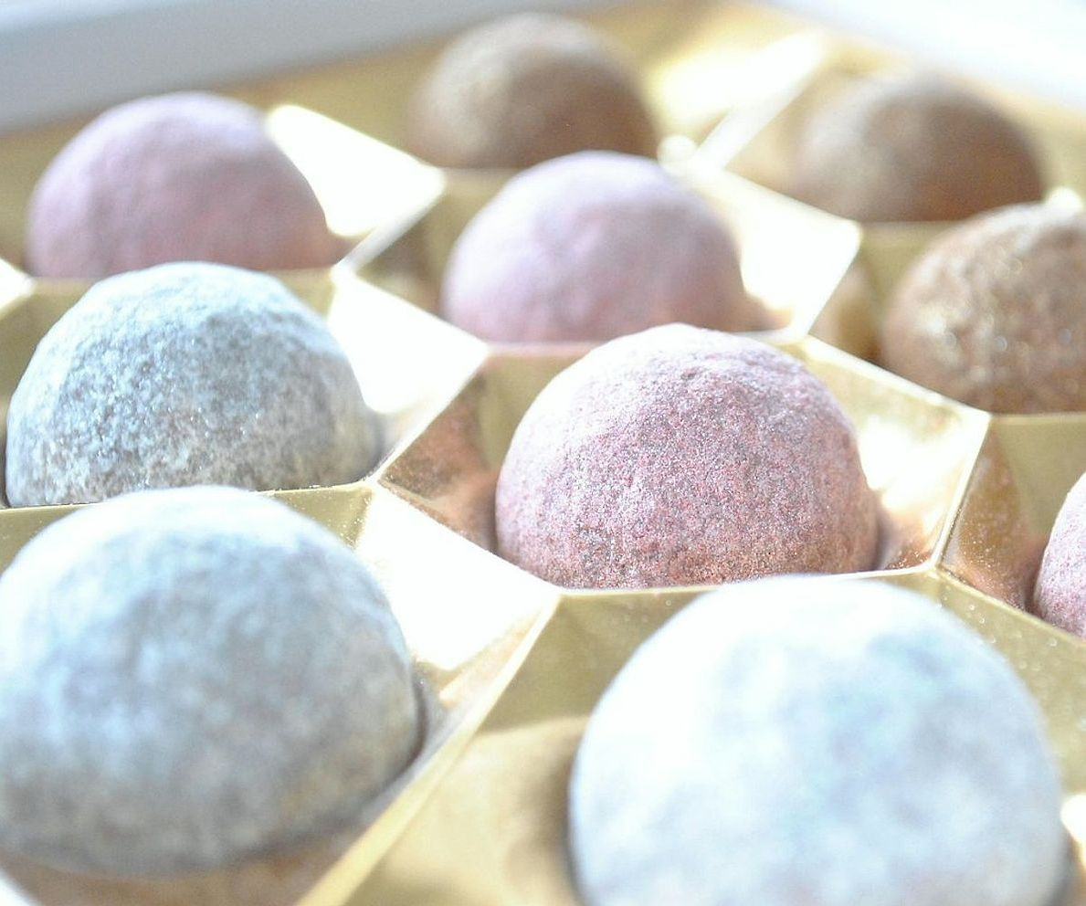 Confectioner carefully tempering premium dark chocolate